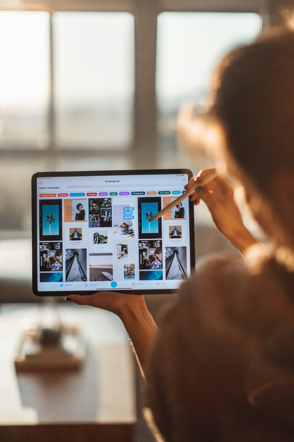 Designer using a tablet to select a template on designlab.